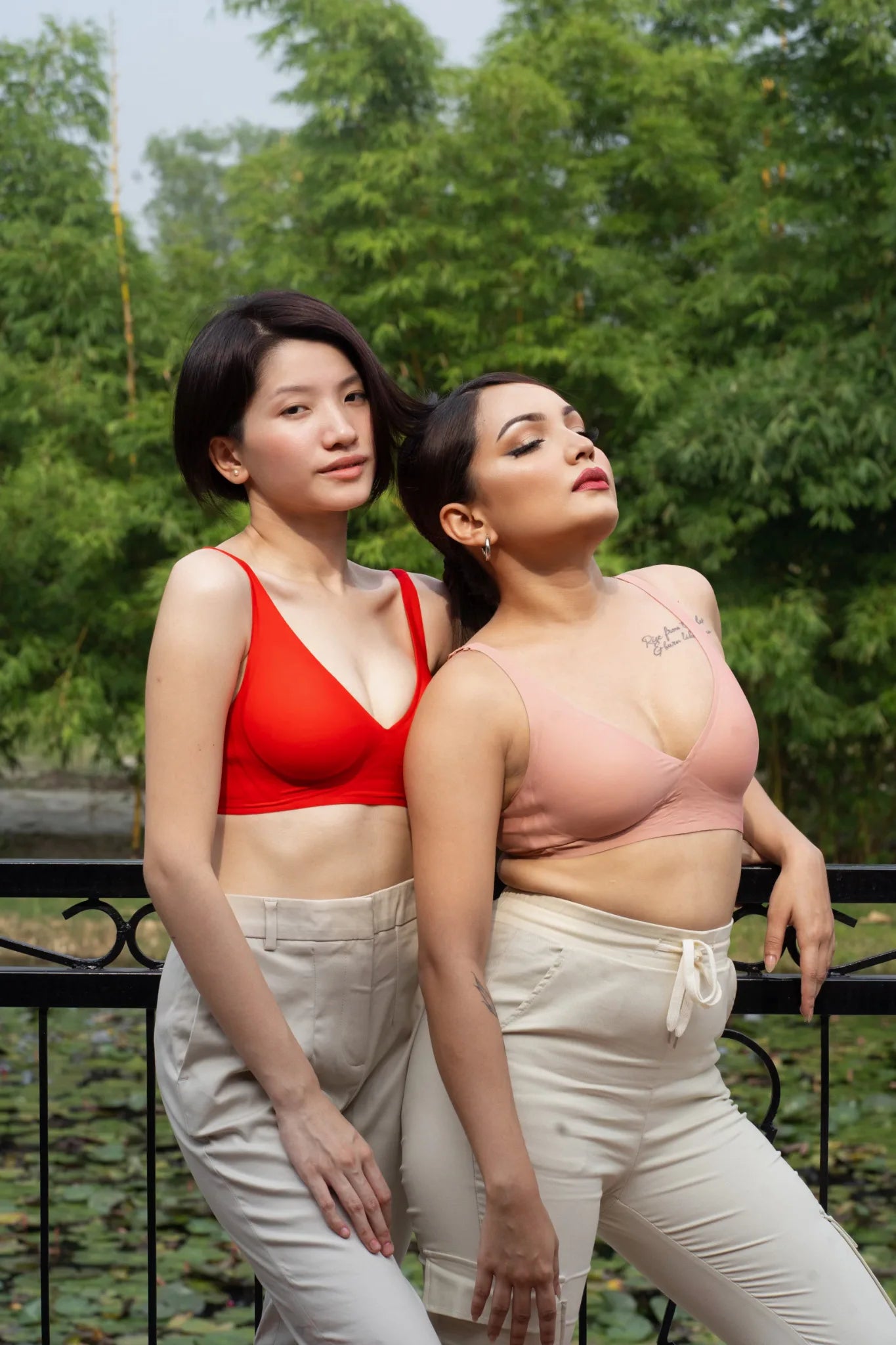 Two models wearing red and blush SHAPE Plunge Lite bras